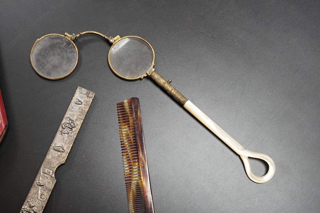 A pair of mother of pearl handled gilt metal lorgnettes in a leather case and a comb housed in an antimony case, largest 16cm in length